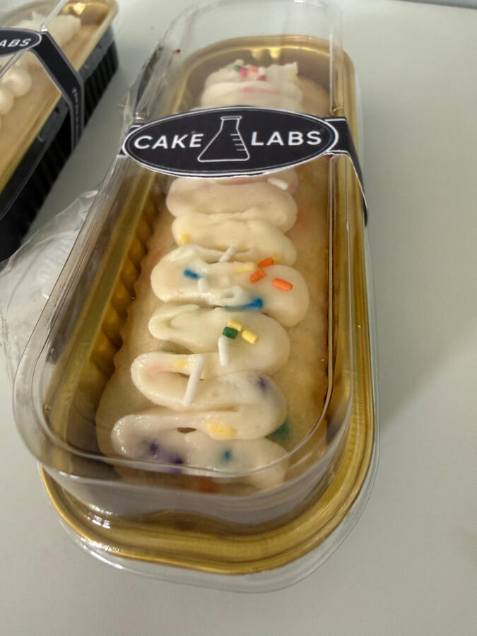 Cake Labs Confetti Protocol mini loaf cake with white chocolate ganache and sprinkles.